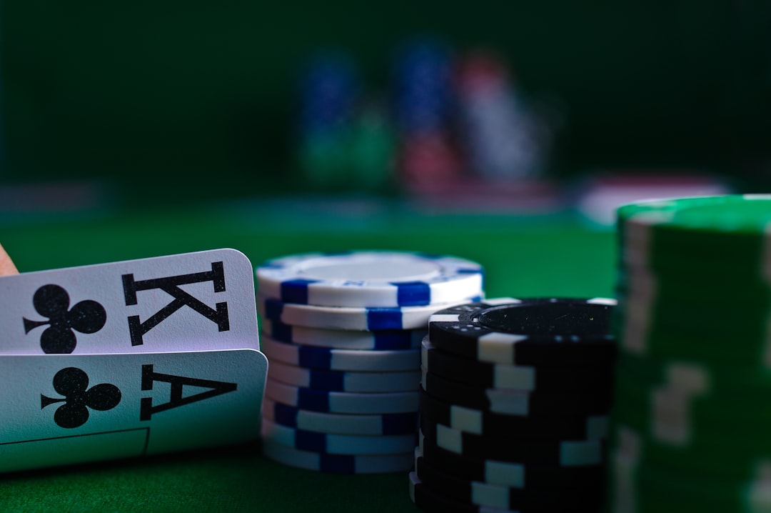 Close-up of playing cards and poker chips on a green felt casino table