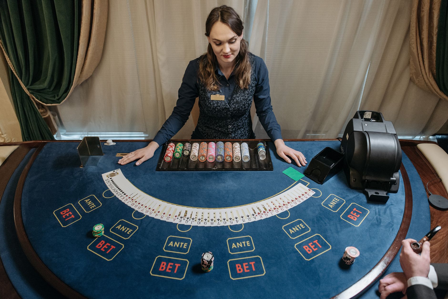 Professional female casino dealer managing a gaming table with chips and cards in a luxurious setting. — 10 Best Real Funds O