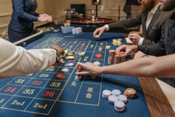 A lively casino scene with players placing bets and handling gaming chips on a roulette table. — Best Ontario Online Casino S