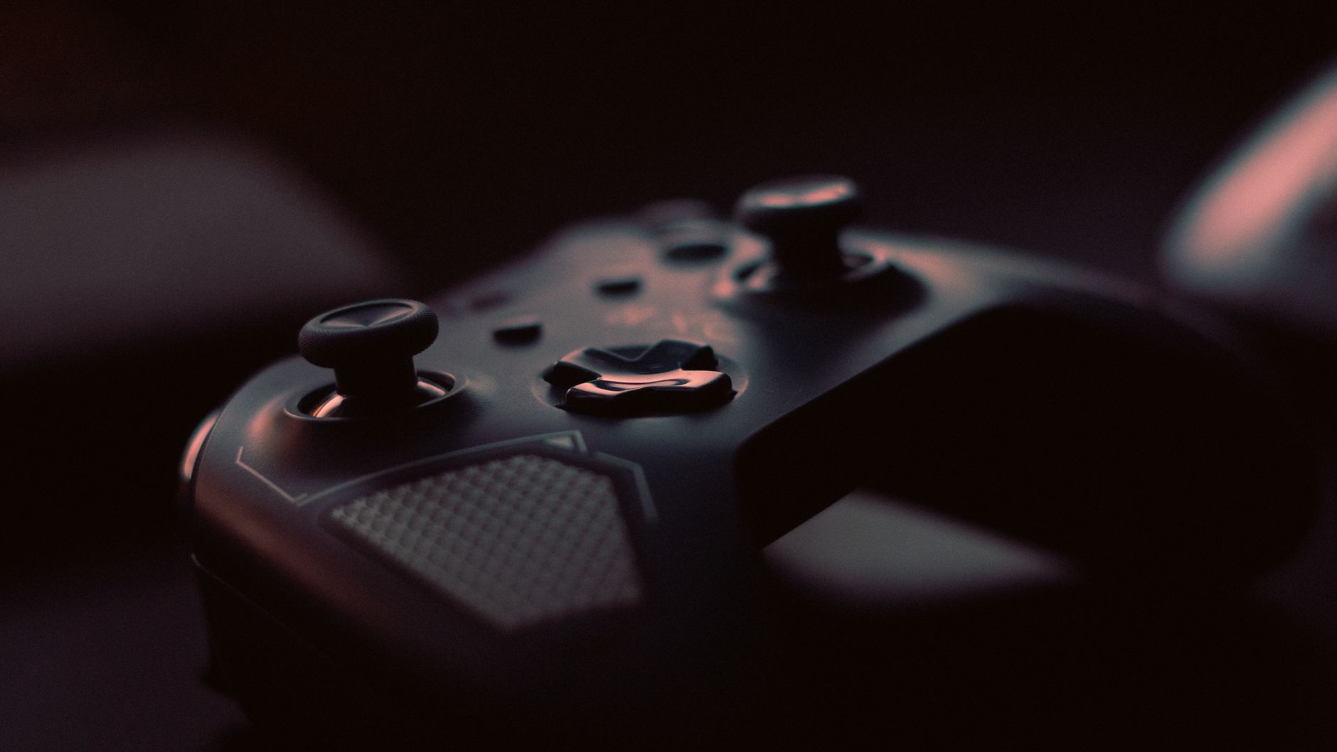 A close-up shot of a game controller in low light, highlighting its design and buttons. — Free Rotates & No Deposit