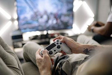 Hands holding a video game controller in a modern living room, playing on TV. — WordPress Update: What's New and Why You