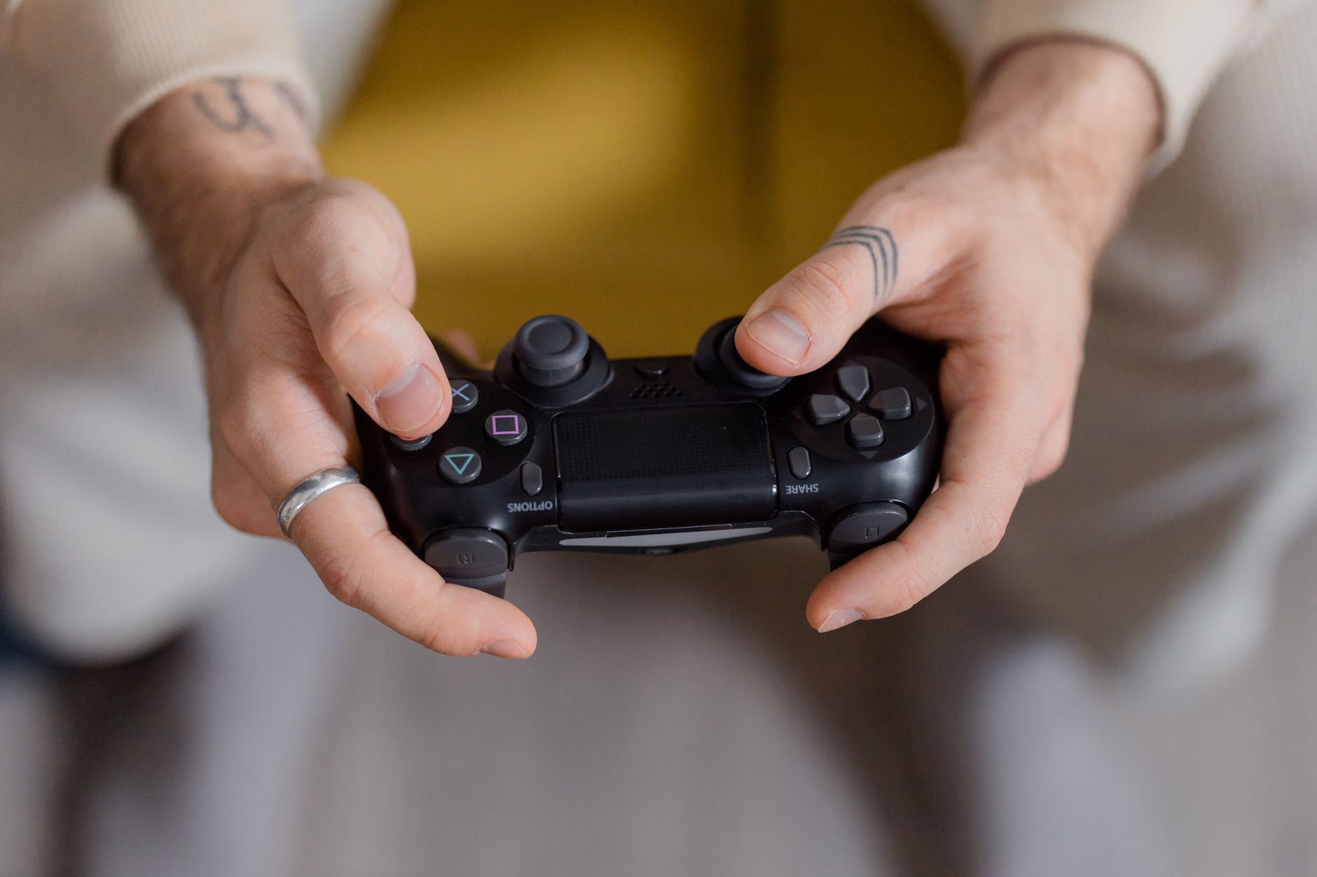 A gamer holding a black game controller, focusing on gaming and entertainment. — Play Online Baccarat and Experience Real Cas