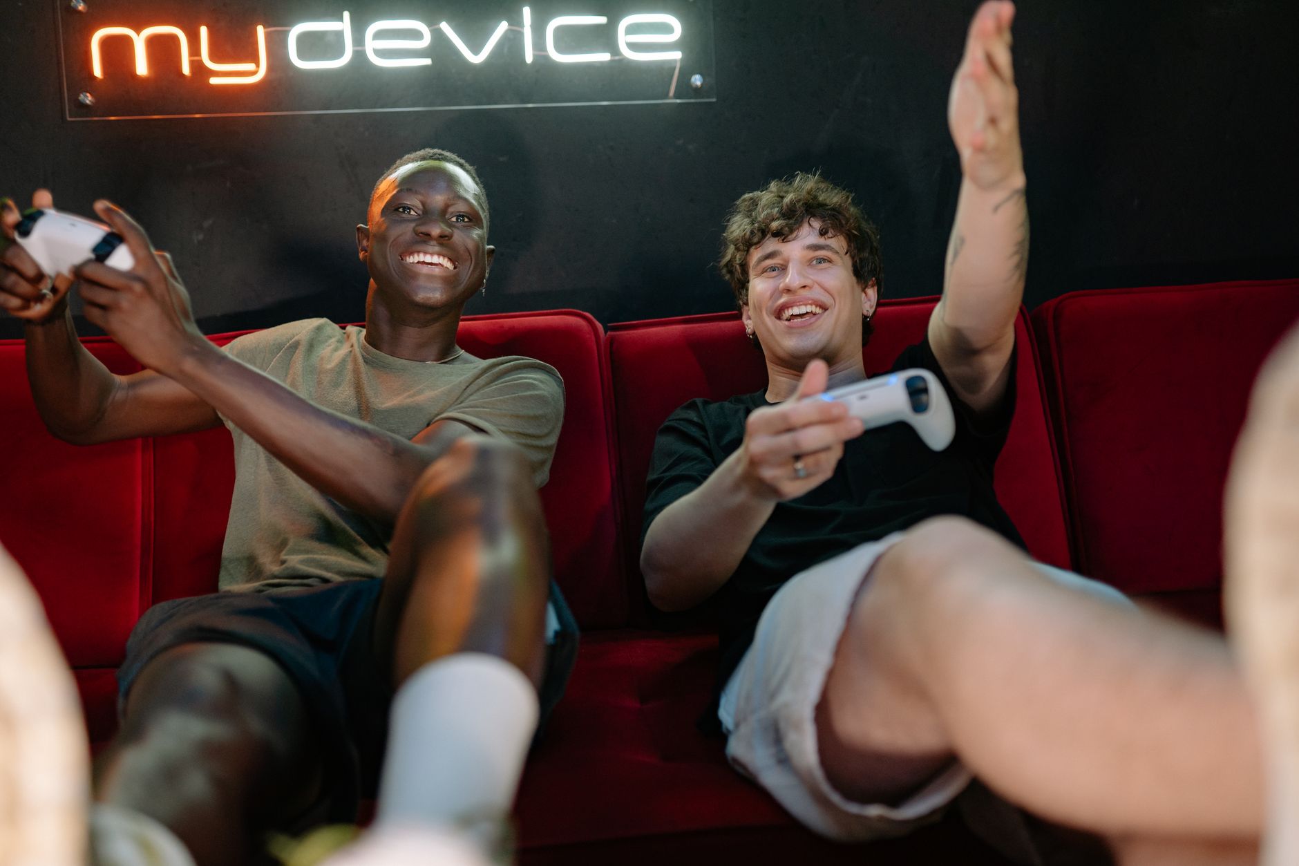 Two friends having fun and playing video games on a couch indoors. — Test Post 2025-07-14 08:45:34