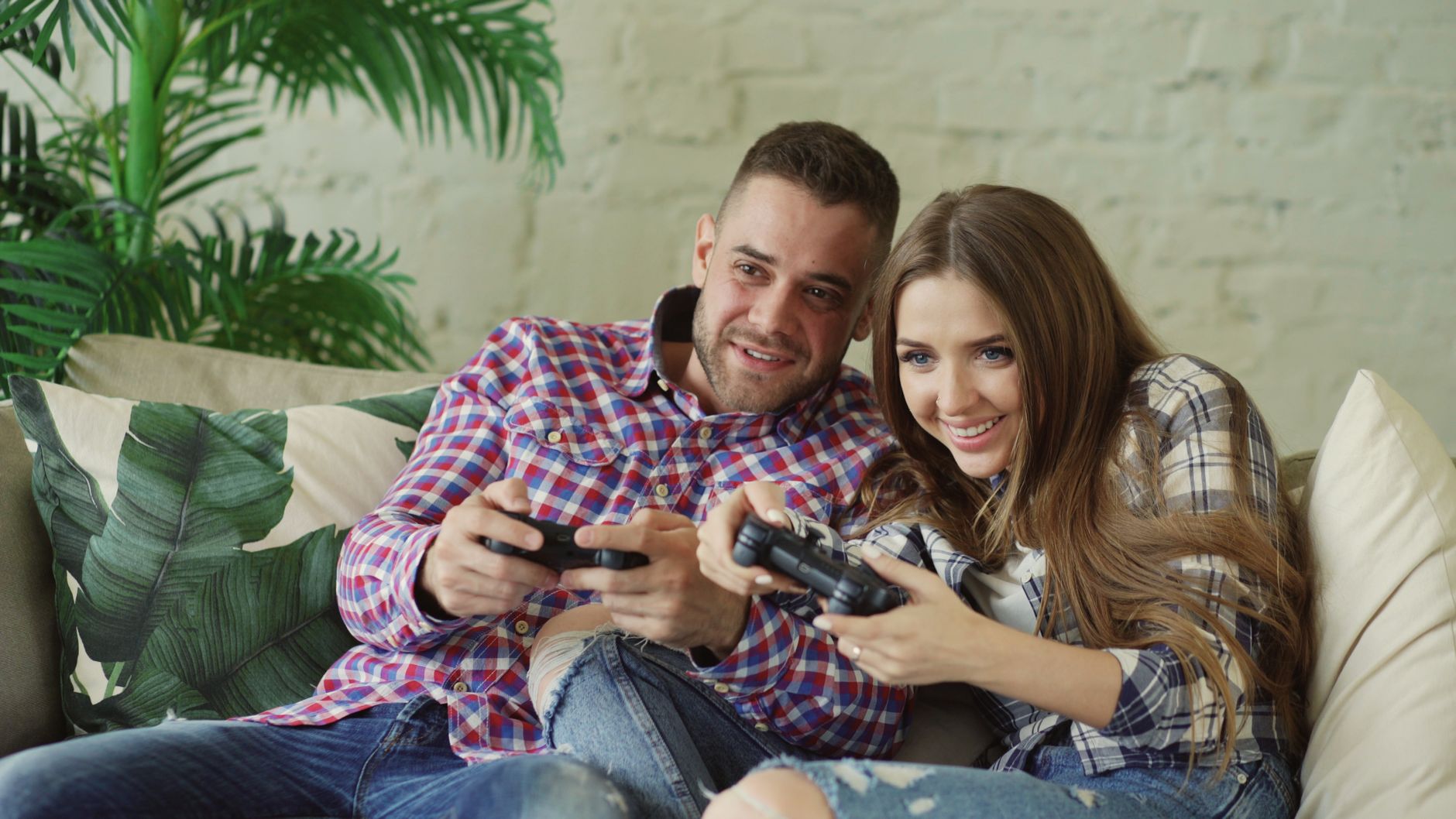 Happy couple enjoying video games together at home on a cozy sofa. — Test Post for WordPress