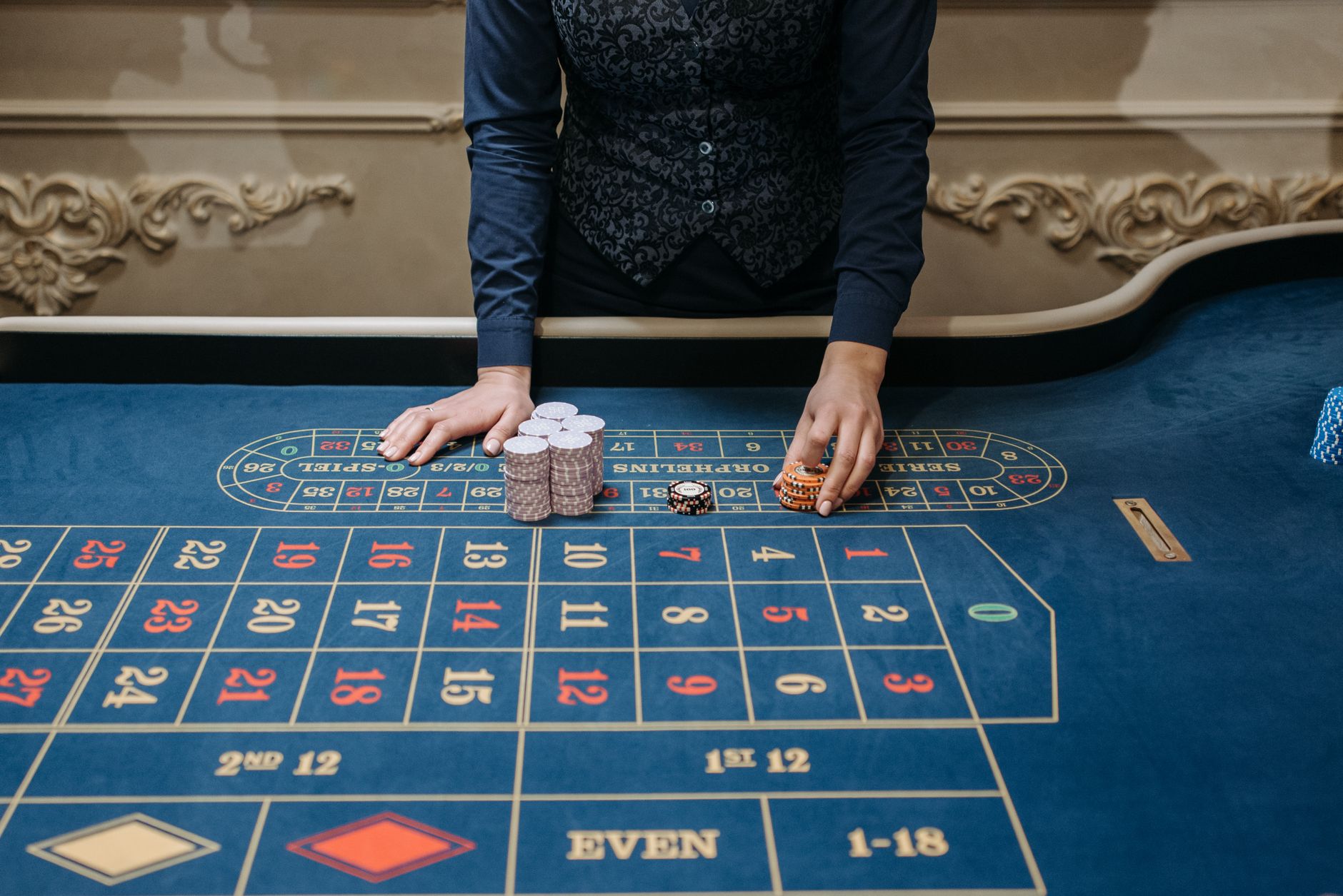 Casino dealer arranging chips on a roulette table in an elegant setting. Perfect for gaming content. — "Top 10 Online Gamblin