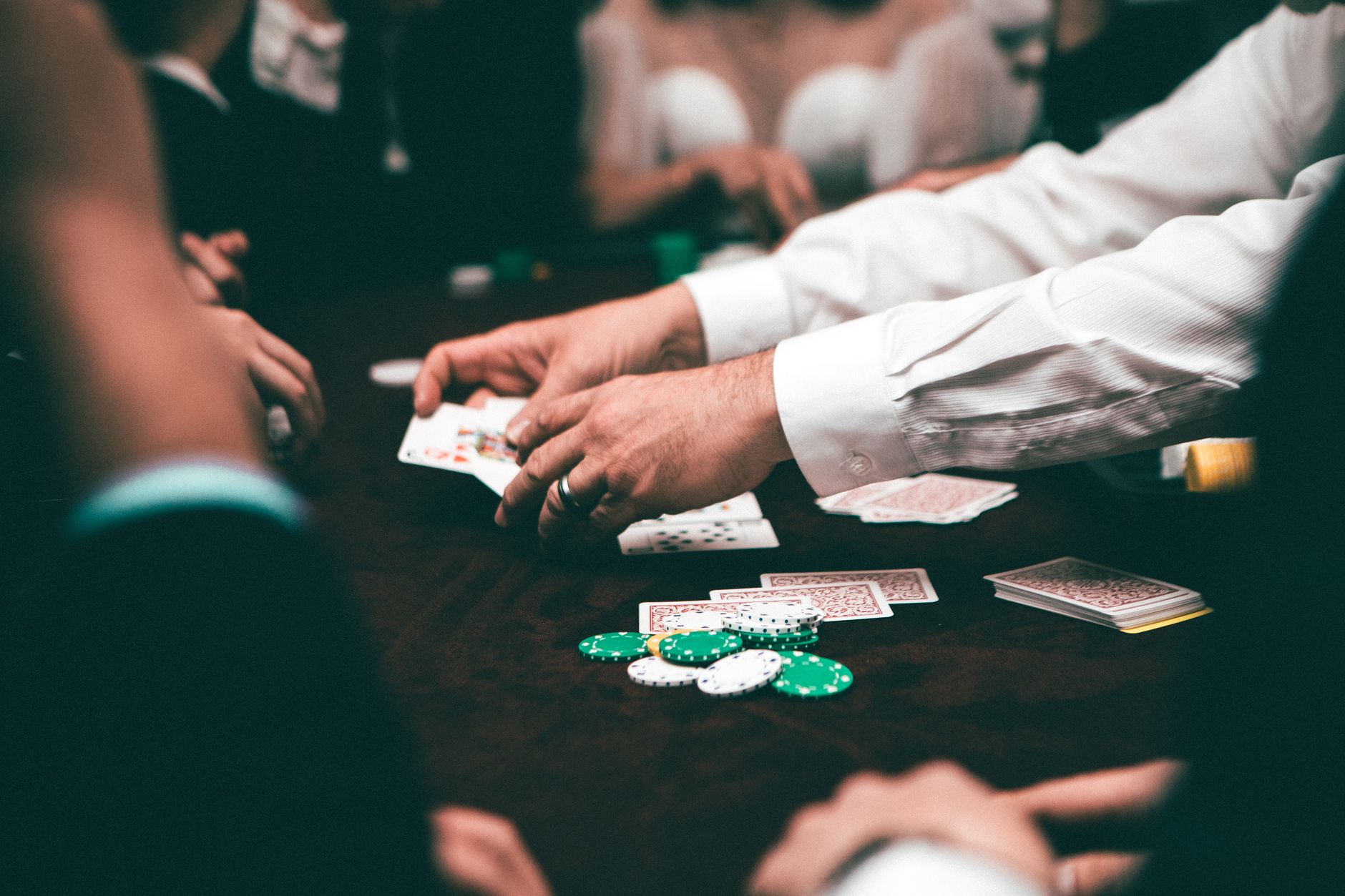 An intense poker game featuring players and poker chips on the table in an indoor setting. — Top Usa Casinos 2024 Finest Onli